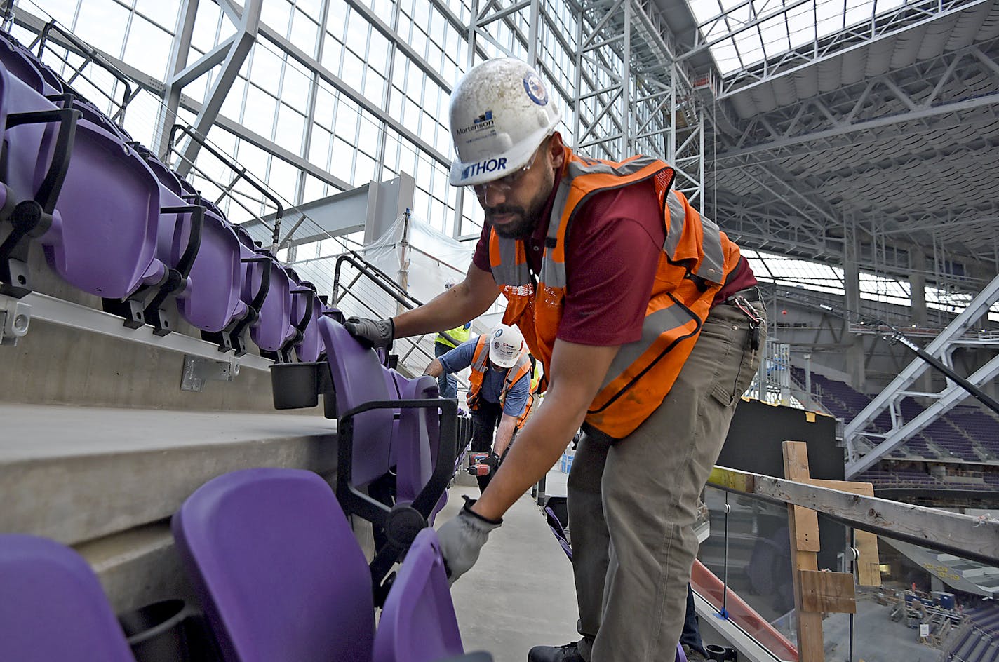 Workers install two rows of seats in section 349 of U.S. Bank Stadium, the new home of the Minnesota Vikings, in Minneapolis, Minn. on Friday March 25, 2016. (Richard Marshall for the Minnesota Vikings) ORG XMIT: rdm new Vikings seats