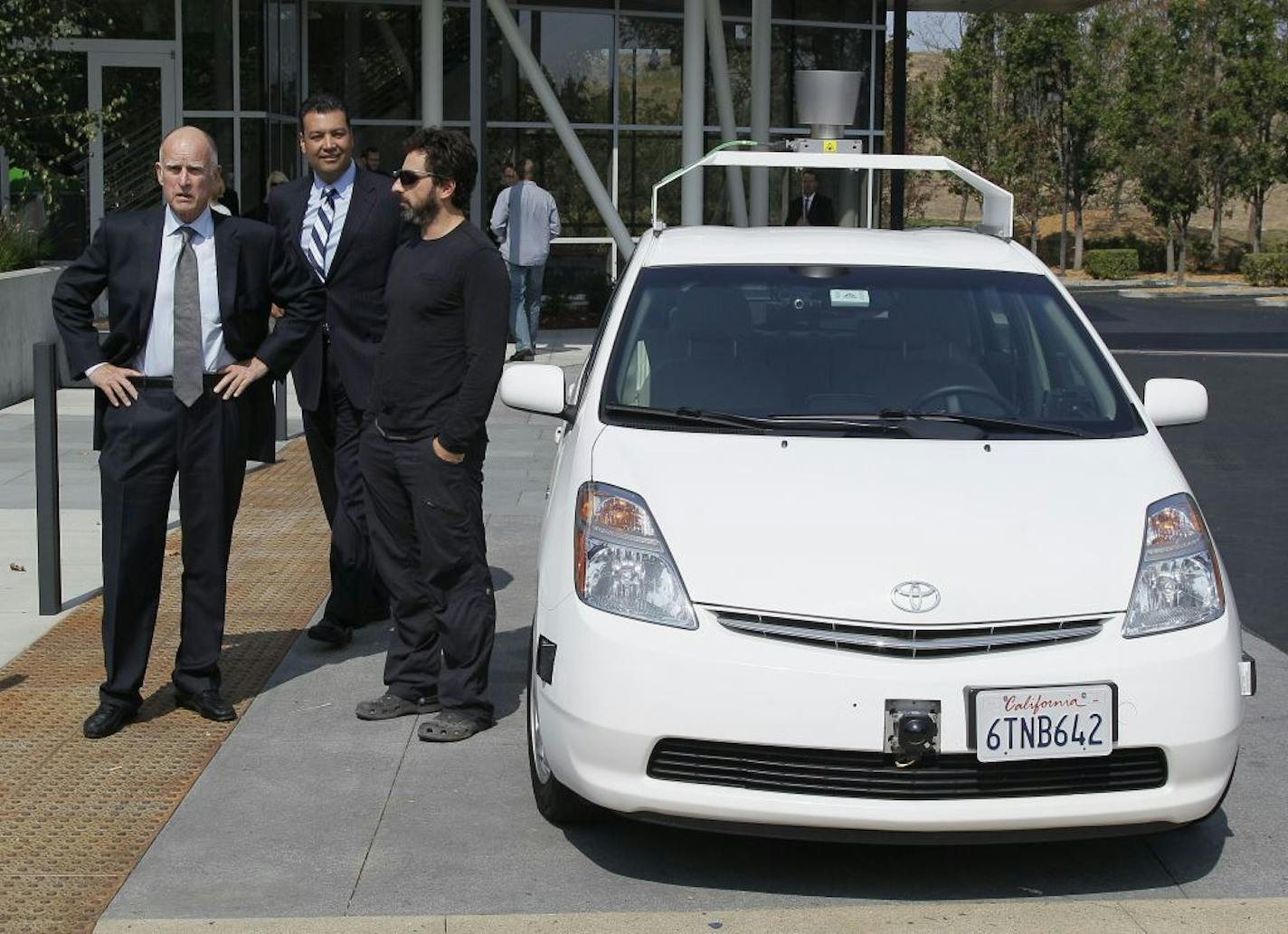 From left, California Gov. Edmund G Brown Jr., state Senator Alex Padilla and Google co-founder Sergey Brin stand by a driverless car they arrived in at Google headquarters in Mountain View, Calif., Tuesday, Sept. 25, 2012. Brown visited Google to sign legislation for driverless cars. The legislation will open the way for driverless cars in the state. Google, which has been developing autonomous car technology and lobbying for the legislation has a fleet of driverless cars that has logged more t