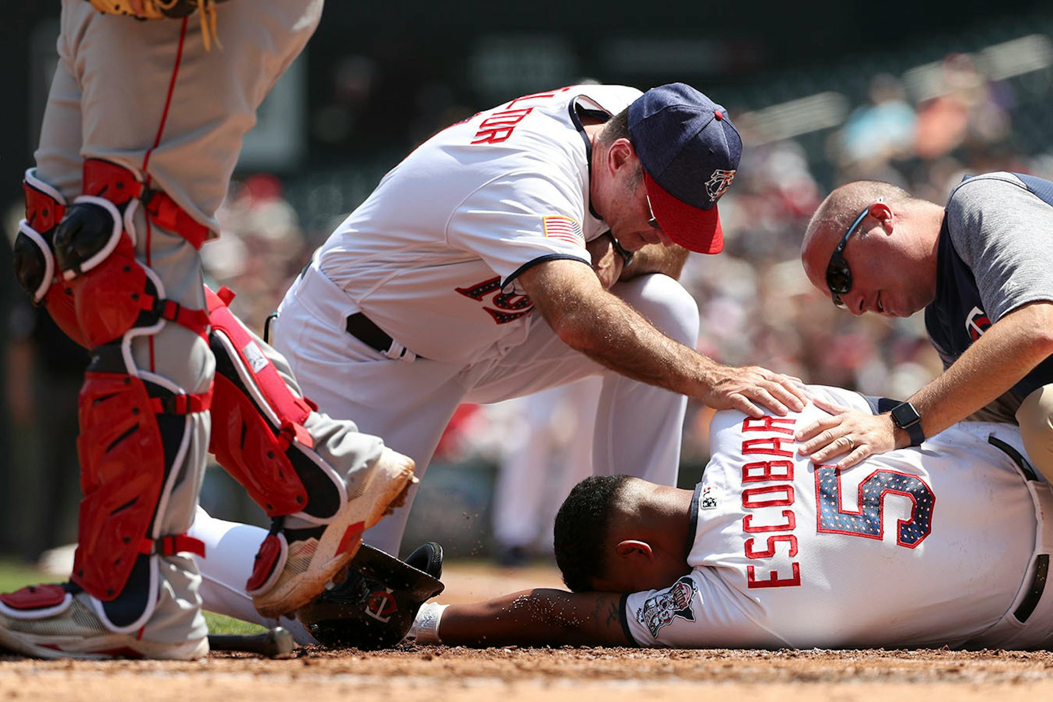 Minnesota Twins third baseman Eduardo Escobar (5) went down after he was hit by a pitch in the second inning.