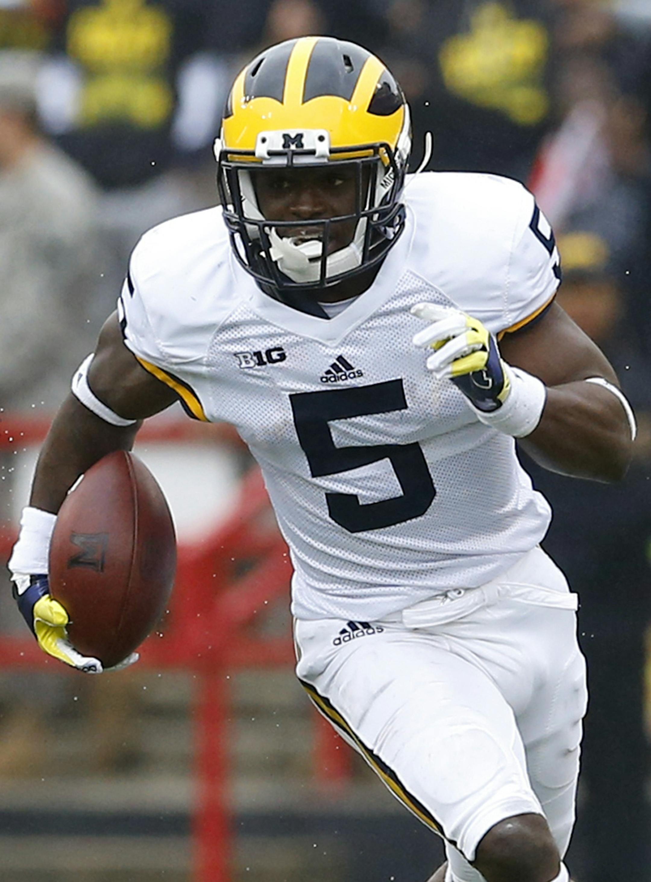 FILE- In this Oct. 3, 2015, file photo, Michigan's Jabrill Peppers carries the ball on a punt return in the first half of an NCAA college football game against Maryland, in College Park, Md. The pool of candidates for the Heisman Trophy is deep. Stanford's Christian McCaffrey and Clemson's Deshaun Watson are among the obvious ones, and Peppers could enter the race if things break right for him. (AP Photo/Patrick Semansky, File)