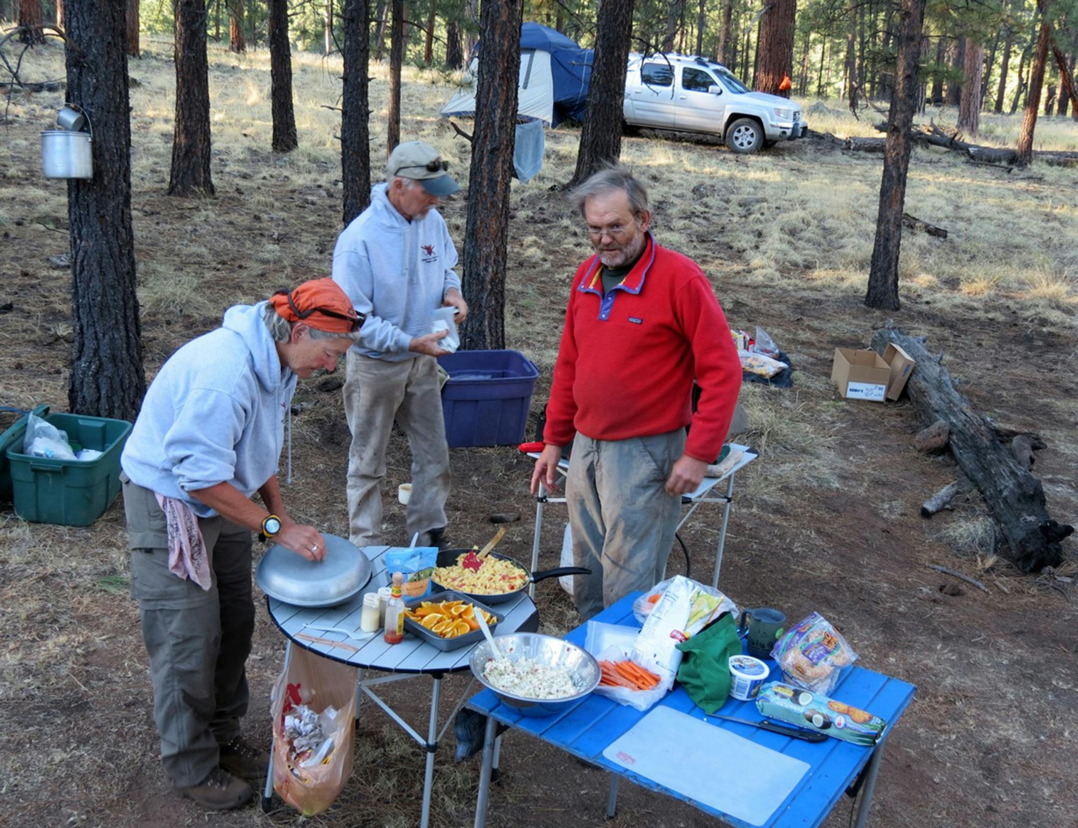 43 WV camp breakfast - Wilderness Volunteers trail builders gather for a camp breakfast of scrambled eggs and orange slices, getting ready for a day of trail building.