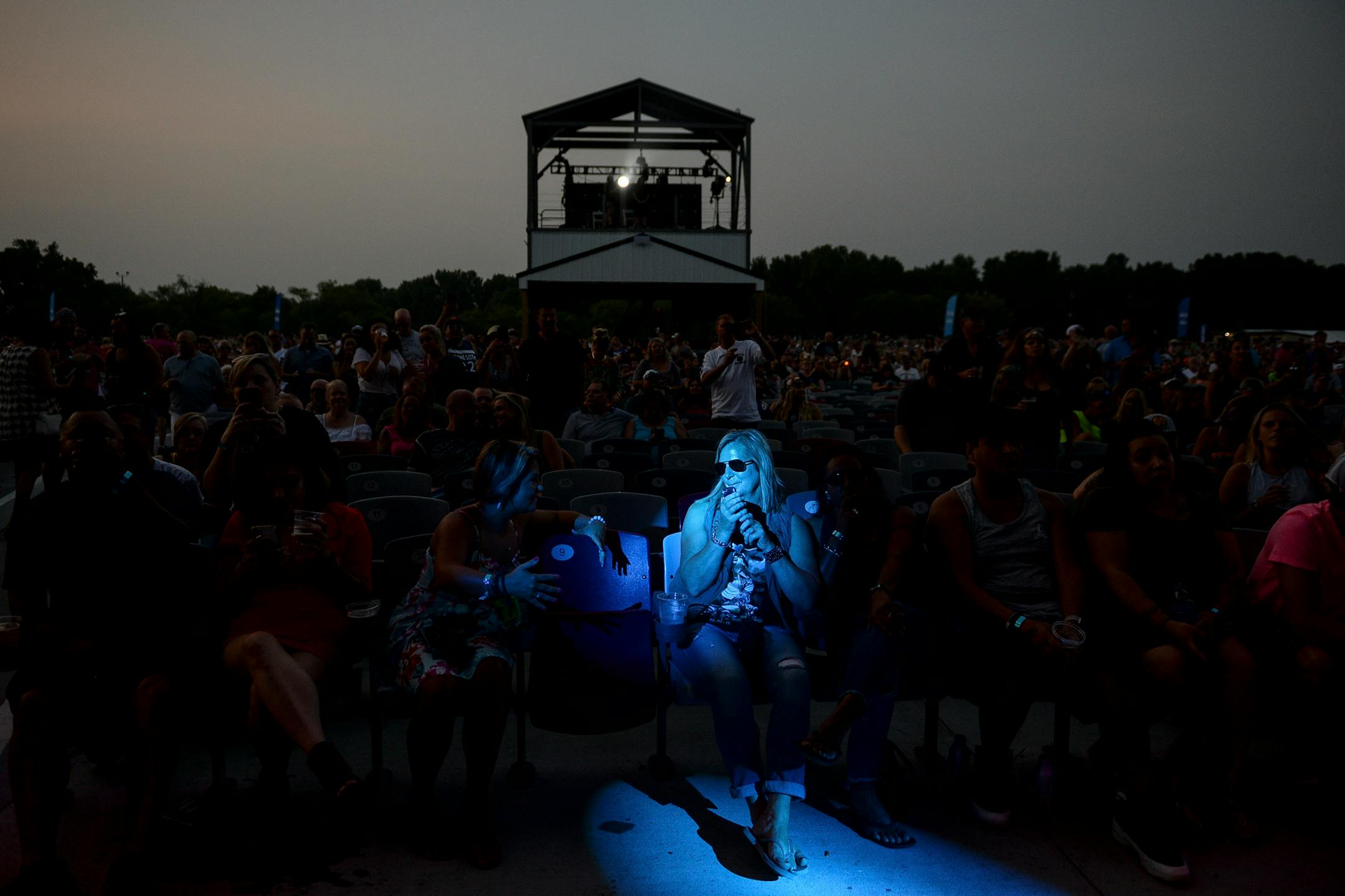 A fan was illuminated by stage lights at Saturday night's Uncle Kracker and Kid Rock concert at Treasure Island. ] AARON LAVINSKY • aaron.lavinsky@startribune.com Kid Rock and Uncle Kracker performed Saturday, August 11, 2018 at Treasure Island Resort and Casino in Welch, Minn.