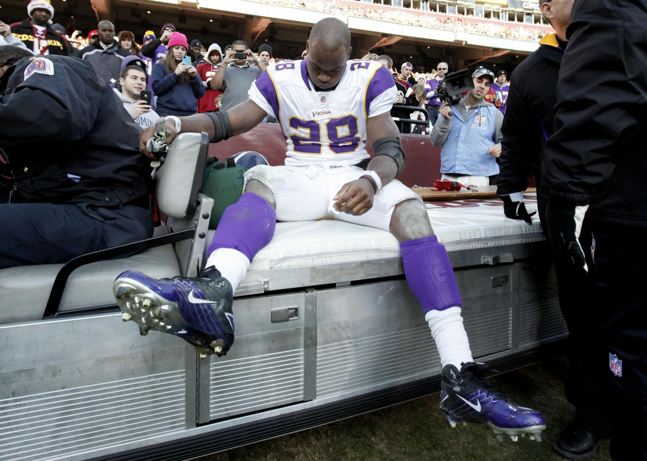 Vikings running back Adrian Peterson left the game on a cart early in the third quarter because of a severe knee injury. He will have surgery Friday.