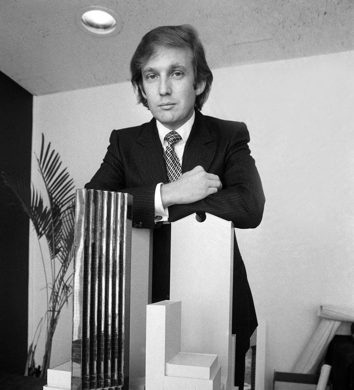 FILE -- Donald Trump with a model of Trump Tower, in New York, Aug. 1, 1980. A model maker's assistant recalls that on one model of the tower and surrounding area, Trump had the GM building, which is taller than Trump Tower and just two blocks away, cut shorter so that his building would appear to be tallest. (Don Hogan Charles/The New York Times)