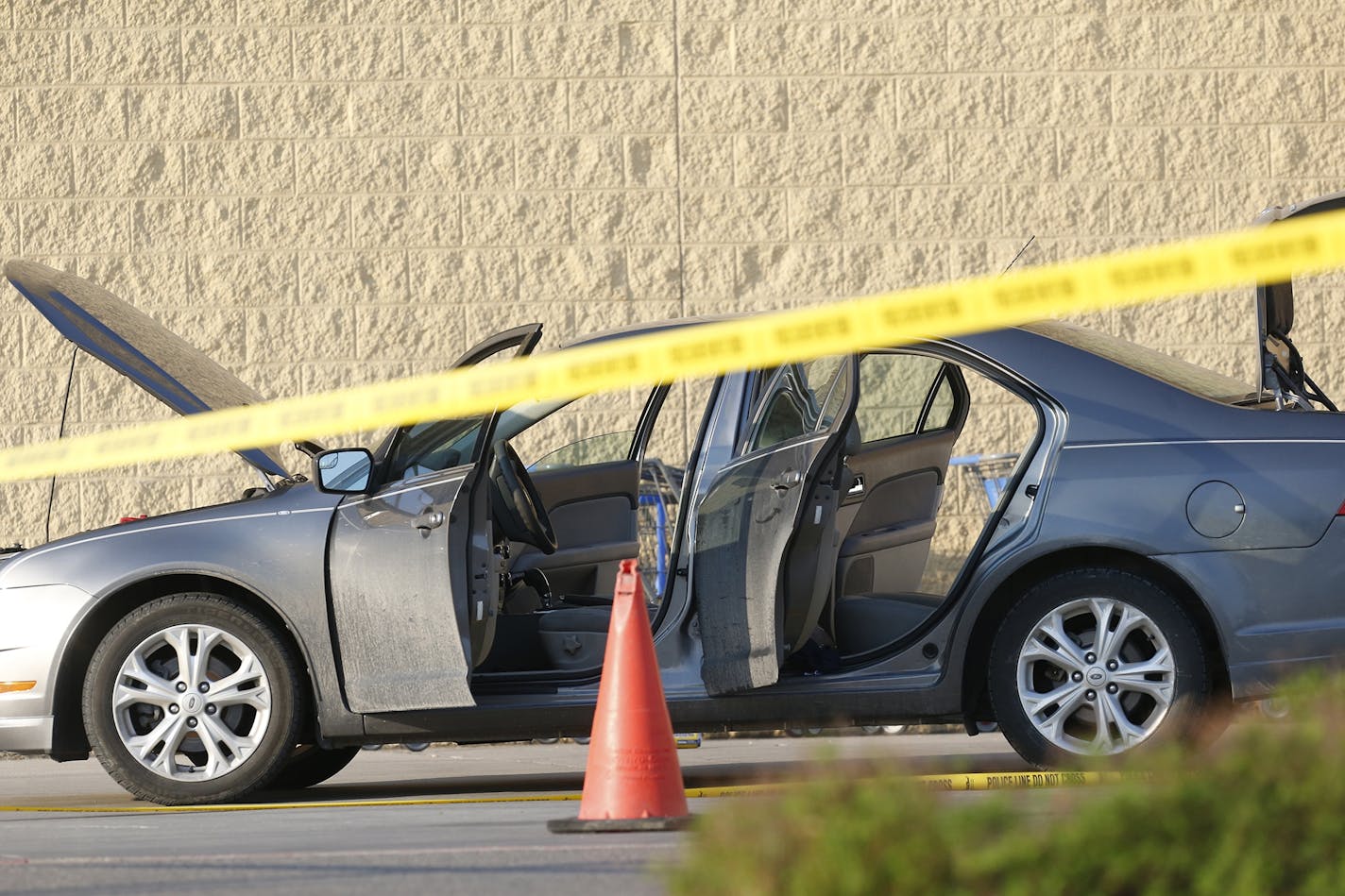 A car was searched near the entrance of Wal-Mart at the scene of a shooting on Tuesday, May 26, 2015, in Grand Forks, N.D.