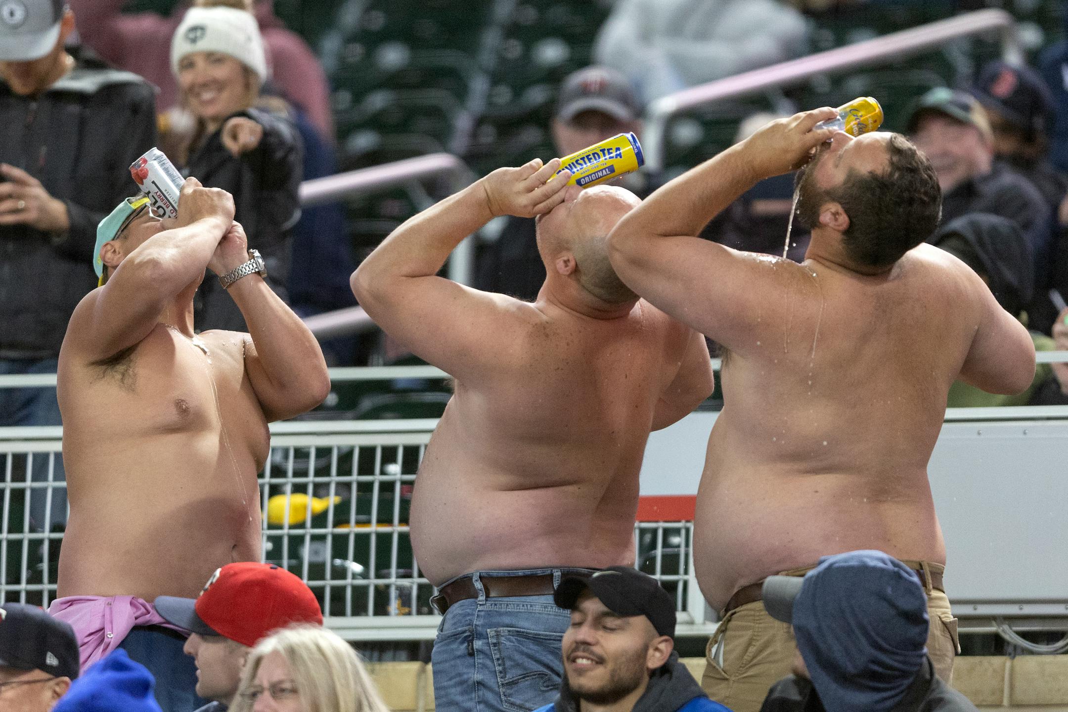 Shirtless fans drank beers in the seventh inning.