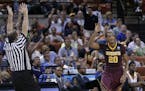 Minnesota's Austin Hollins gestures after hitting a 3-point shot against UCLA in the 2013 Sweet 16.