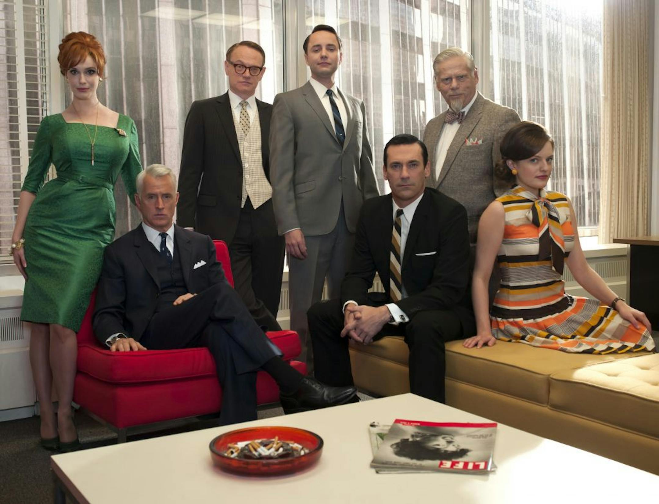 In this undated image released by AMC, the cast of "Mad Men," from left, Christina Hendricks, John Slattery, Jared Harris, Vincent Kartheiser, Jon Hamm, Robert Morse and Elisabeth Moss are shown. The fifth season the stylized AMC drama about the men and women who work in Madison Avenue advertising in the 1960s, premieres March 25, 2012 at 9 p.m. EST on AMC.