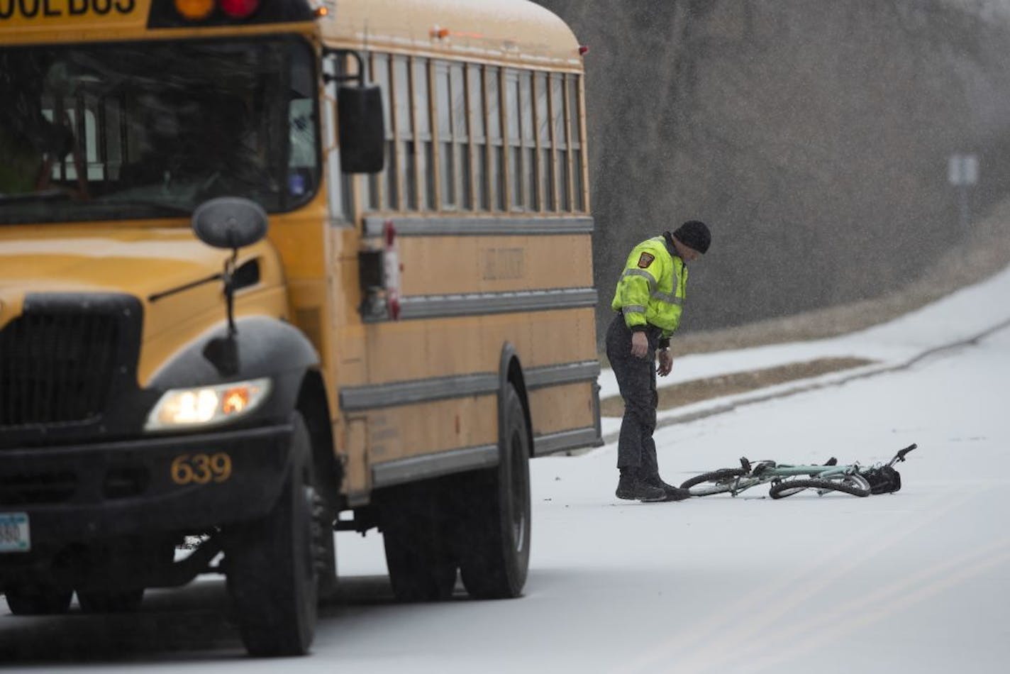 A Minnesota State Trooper investigated the scene where a bicyclist was killed after colliding with a school bus Wednesday morning on Zane Avenue and 65th Avenue in Brooklyn Park.