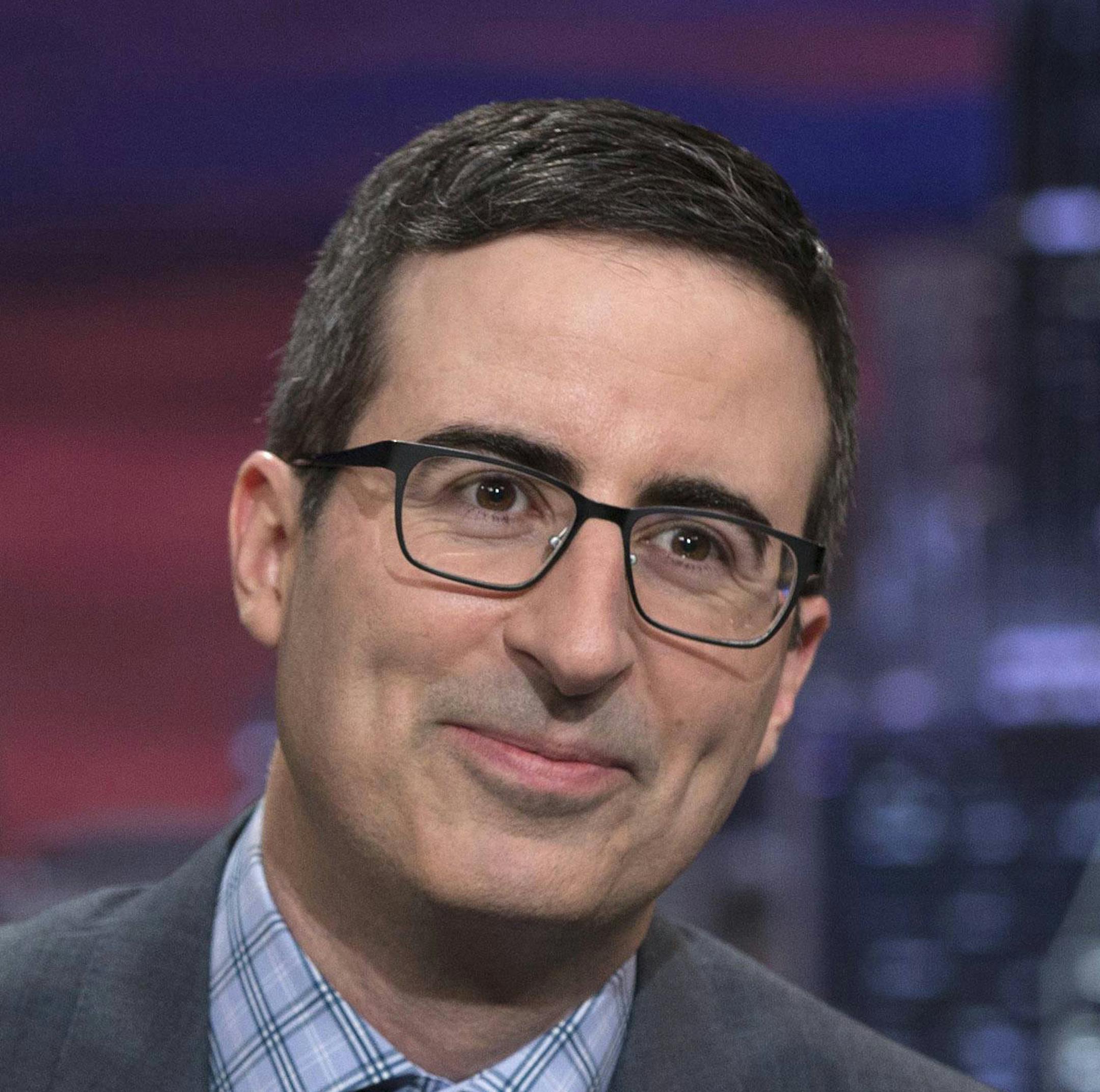 This image released by HBO shows John Oliver on the set of "Last Week Tonight with John Oliver." With the return of Oliver to HBO and Alec Baldwin’s guest hosting slot on “Saturday Night Live,” this is shaping up like a big weekend for late-night’s treatment of the new president. (Eric Liebowitz/HBO via AP)