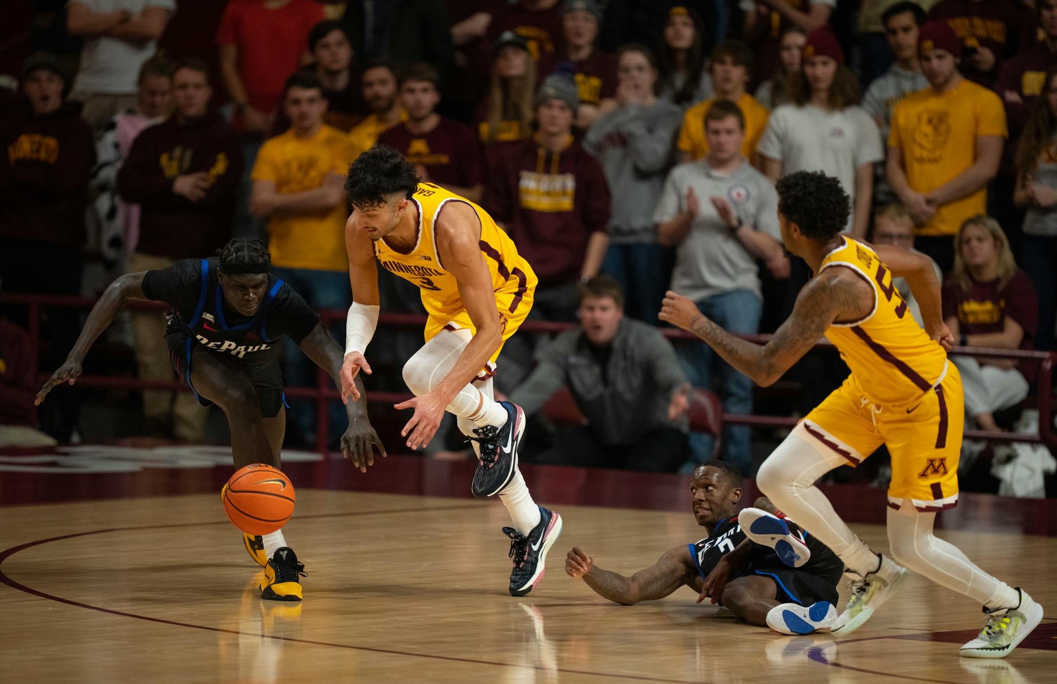Minnesota Gophers forward Dawson Garcia (3) beat DePaul Blue Demons forward Yor Anei (10) to the ball after DePaul Blue Demons guard Umoja Gibson (2) lost control of it in the second half.