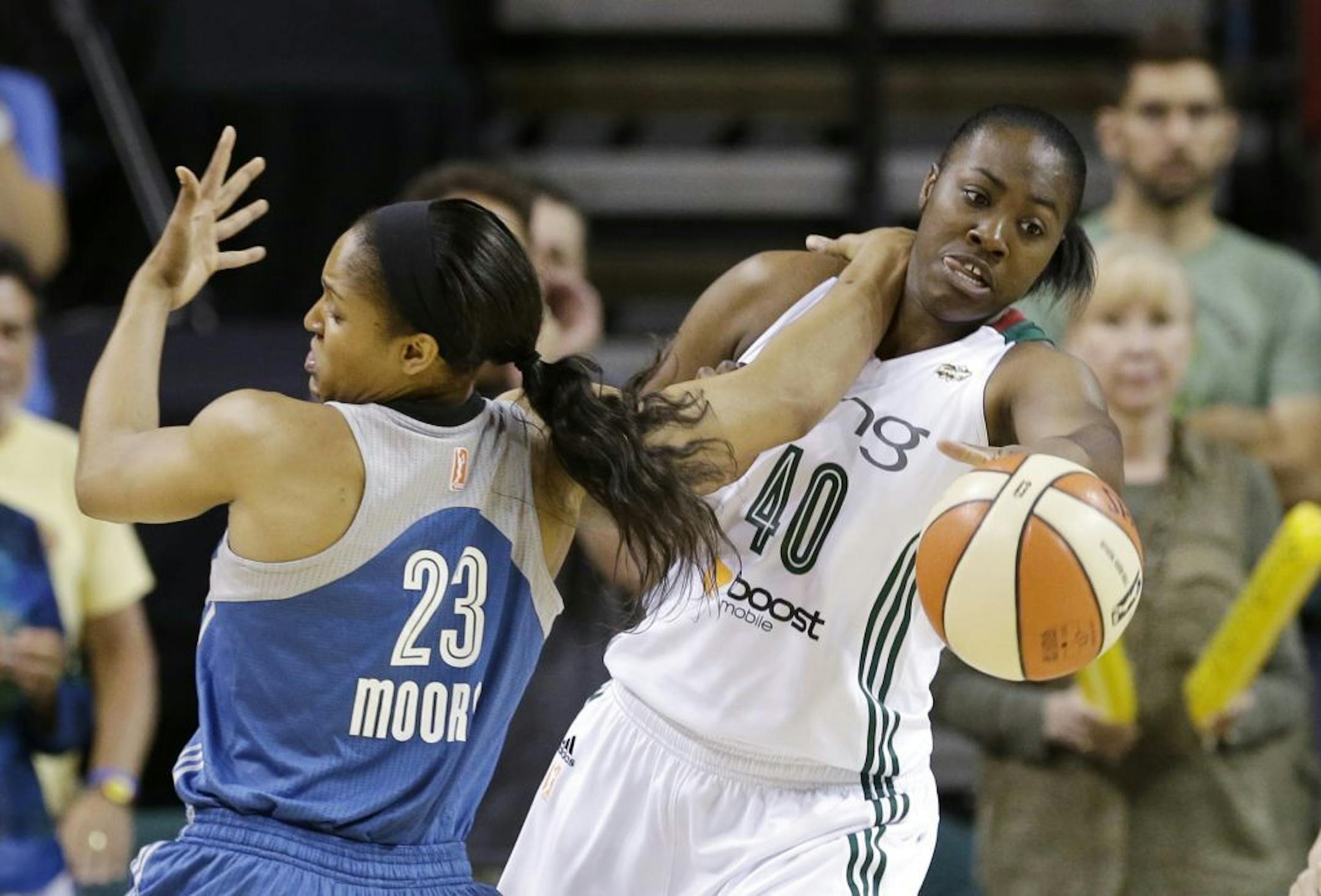 Seattle Storm's Shekinna Stricklen (40) and Minnesota Lynx's Maya Moore tangle as they chase a loose ball in the first half of a WNBA basketball game Tuesday, Sept. 10, 2013, in Seattle.
