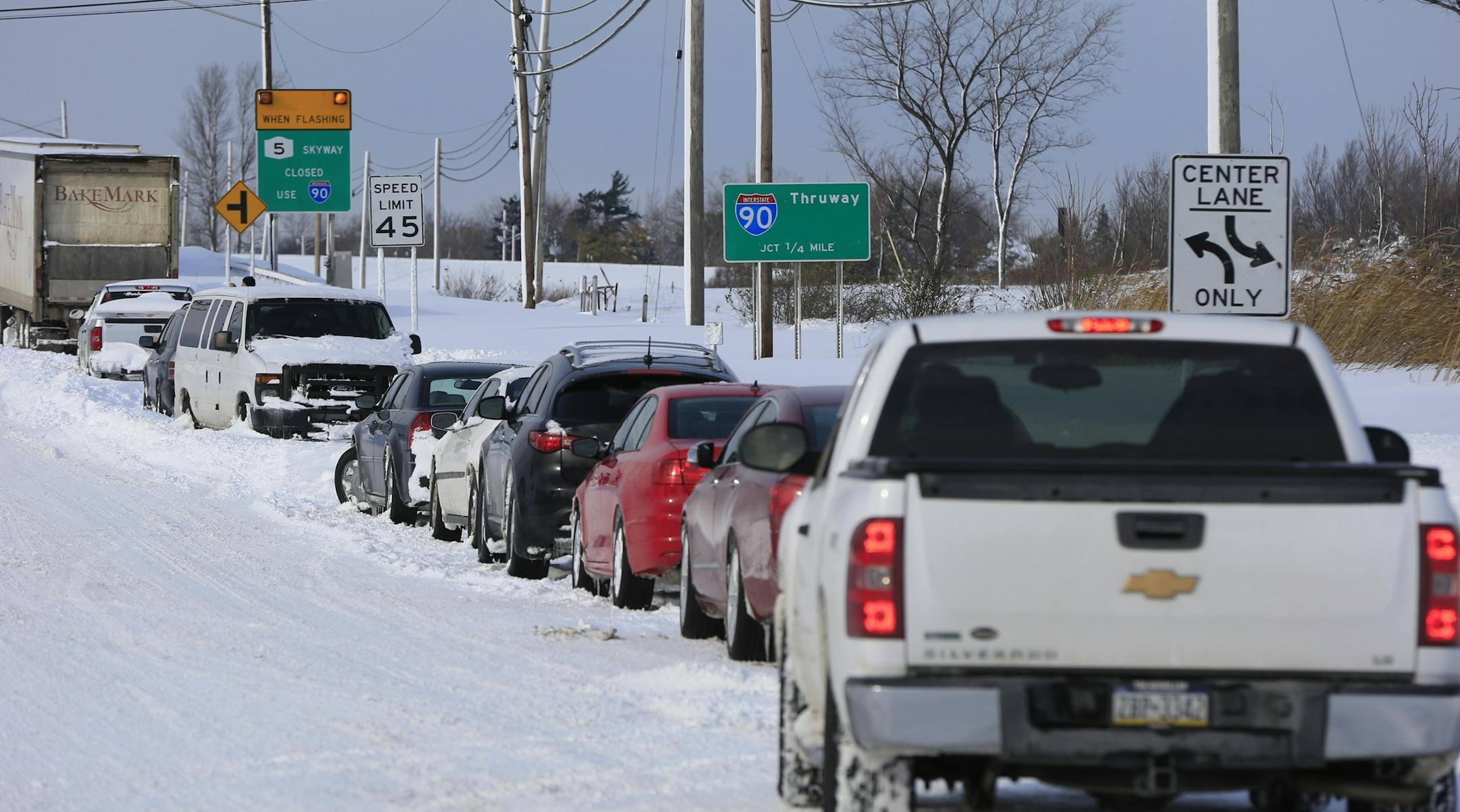Vehicles sit at a closed New York Thruway entrance in Hamburg, N.Y. on Wednesday, Nov. 19, 2014. A ferocious lake-effect storm left the Buffalo area buried under 6 feet of snow Wednesday, trapping people on highways and in homes, and another storm expected to drop 2 to 3 feet more was on its way. (AP Photo/The Buffalo News, Harry Scull Jr.) TV OUT; MAGS OUT; MANDATORY CREDIT; BATAVIA DAILY NEWS OUT; DUNKIRK OBSERVER OUT; JAMESTOWN POST-JOURNAL OUT; LOCKPORT UNION-SUN JOURNAL OUT; NIAGARA GAZETTE