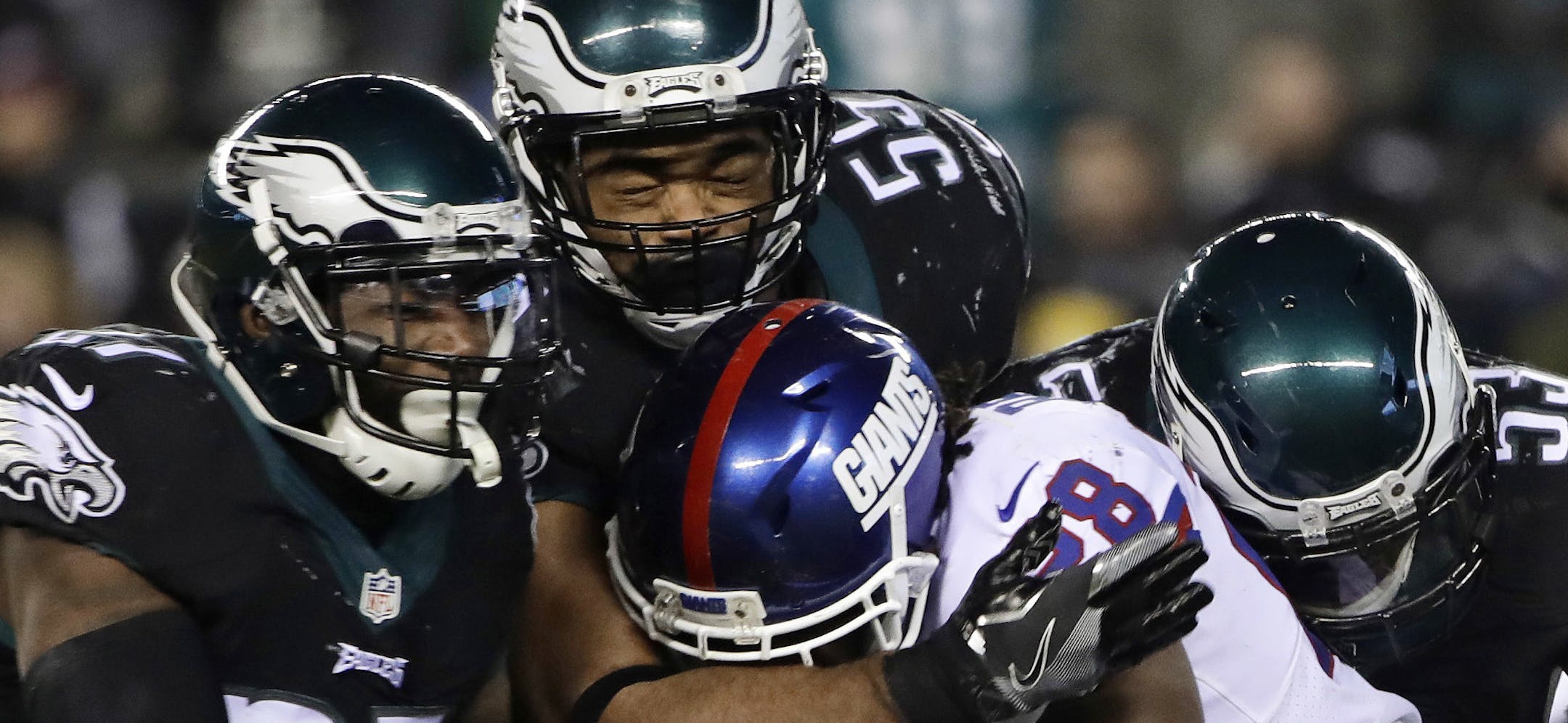 Philadelphia Eagles' Malcolm Jenkins (27), Brandon Graham (55) and Nigel Bradham (53) tackle New York Giants' Paul Perkins (28) during the second half of an NFL football game, Thursday, Dec. 22, 2016, in Philadelphia. (AP Photo/Matt Rourke) ORG XMIT: PXE123