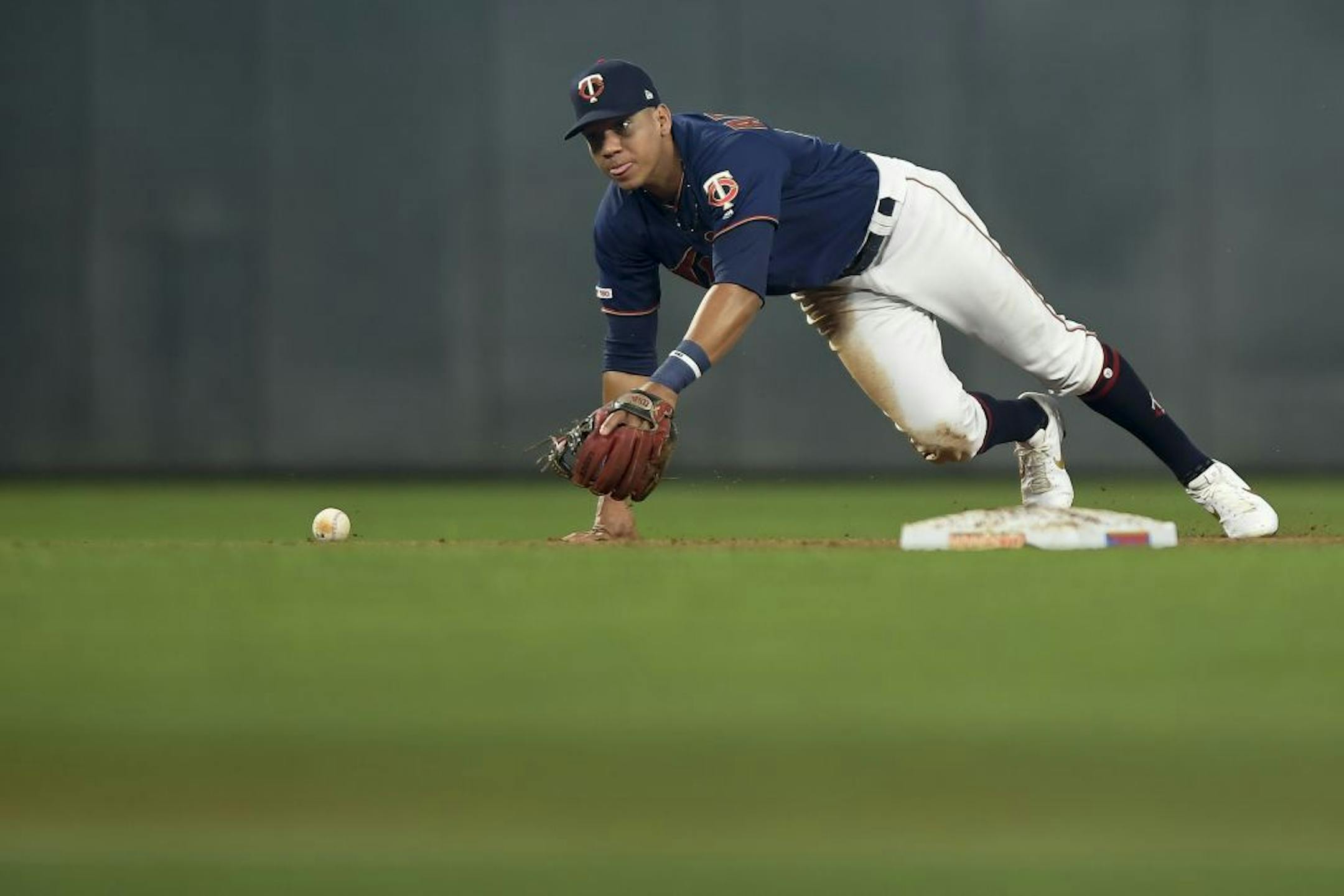 Minnesota Twins shortstop Ehire Adrianza (13) bobbled a ground ball hit by Cleveland Indians right fielder Tyler Naquin (30) in the top of the second inning, allowing a single.