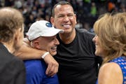 Marc Lore and Alex Rodriguez embrace at Target Center in 2022 as Glen Taylor and his wife Becky look on.