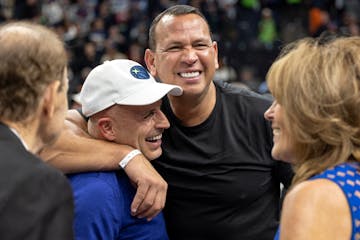 Marc Lore and Alex Rodriguez embrace at Target Center in 2022 as Glen Taylor and his wife Becky look on.