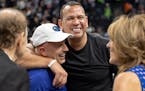Marc Lore and Alex Rodriguez embrace at Target Center in 2022 as Glen Taylor and his wife Becky look on.