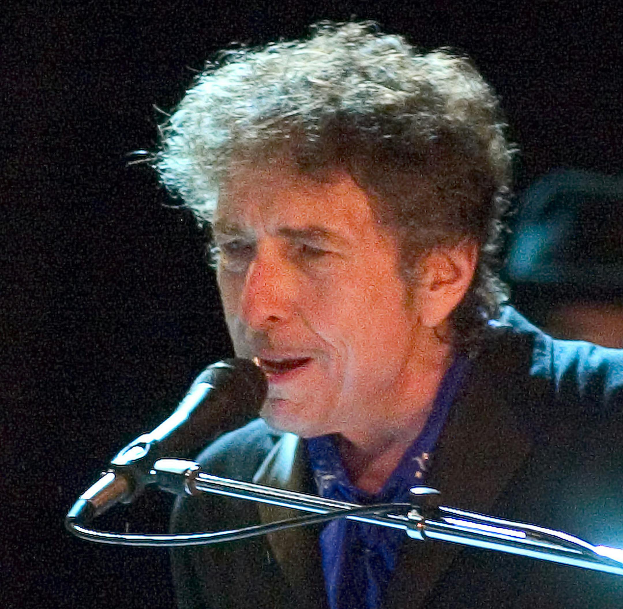 FILE - In this Aug. 26, 2006 file photo, Bob Dylan performs as the opening act of the Pawtucket Arts Festival at McCoy Stadium, in Pawtucket, R.I. Rock legend Bob Dylan was treated like a complete unknown by police in a New Jersey shore community when a resident called to report someone wandering around the neighborhood. Long Branch business administrator Howard Woolley says a 24-year-old police officer apparently was unaware of who Dylan is and asked him for identification.