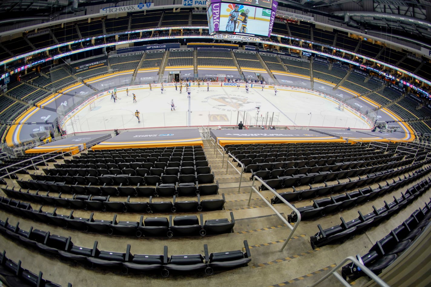 The Ice Crew clears the snow from the rink during a timeout during the second period of an NHL hockey game between the Pittsburgh Penguins and the Washington Capitals at PPG Paints Arena with no spectators in attendance, Sunday, Feb. 14, 2021, in Pittsburgh. (AP Photo/Keith Srakocic)