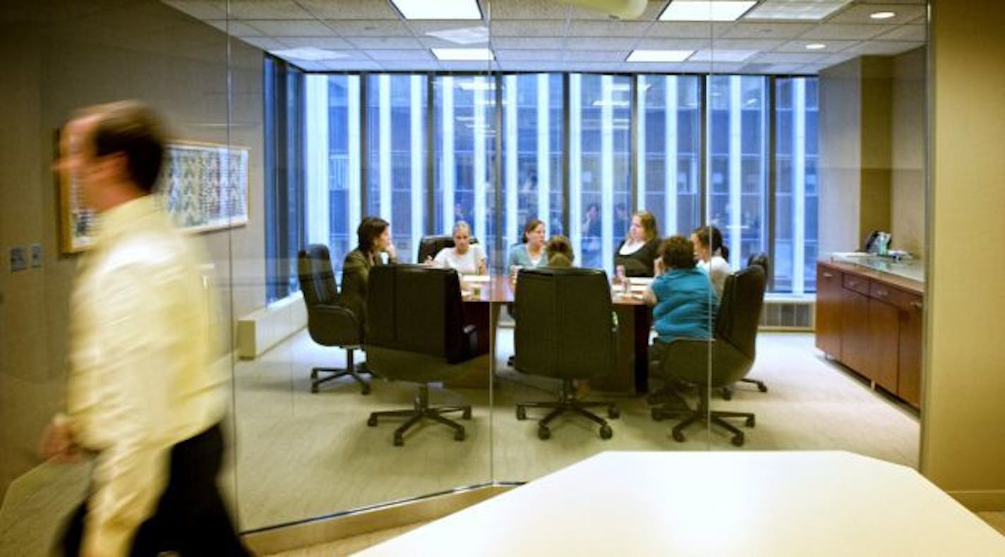 A weekly business development meeting at Gray Plant Mooty, where pay cuts for hourly and salaried workers have been restored.