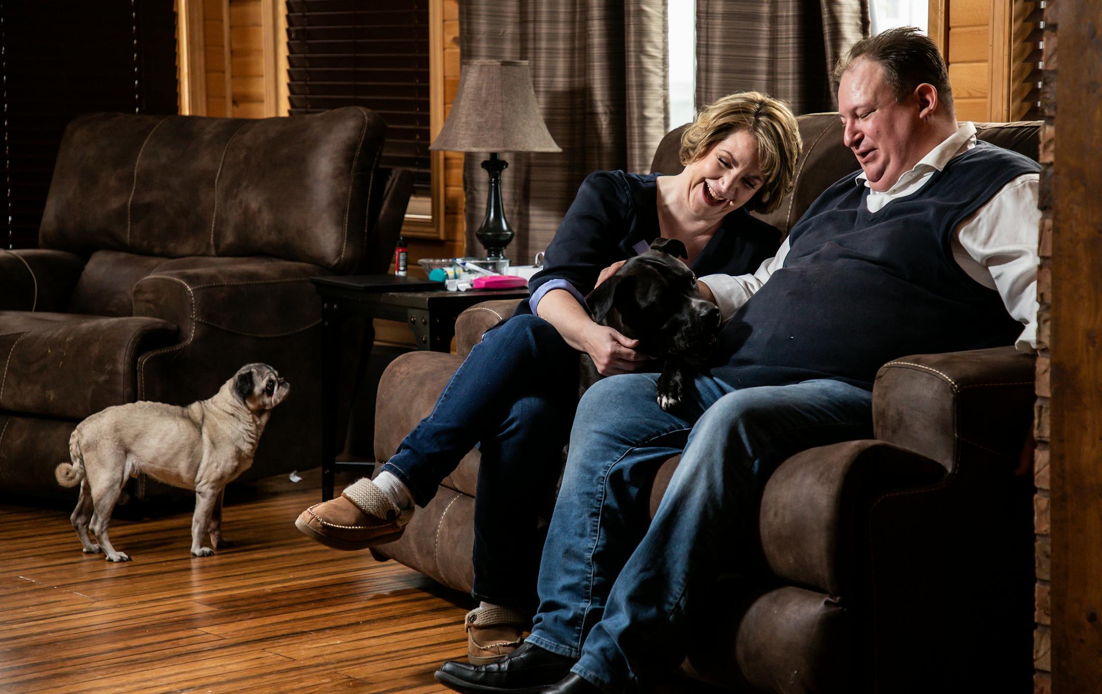 Angela, 43, and Brad Andrews, 42, with dogs "Zeus" and "Oliver," left, at their home in Crown Point on Monday, Nov. 4. 2019. They were married on Dec. 11, 2018, with help of the Wish Upon A Wedding, a Midwest-based nonprofit, granting weddings and vow renewals to couples facing serious illness or a life-altering circumstance. (Zbigniew Bzdak/Chicago Tribune/TNS) ORG XMIT: 1482415 ORG XMIT: MIN1911081051181054