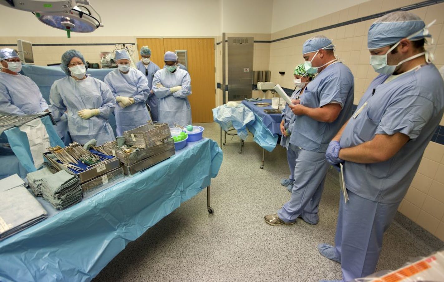 Jason Murphy, second from right, a LifeSource surgical recovery coordinator, and his surgical team took a moment of silence before an organ recovery last month at Fairview Southdale Hospital in Edina. More than 2,500 kidneys from deceased donors are discarded every year.