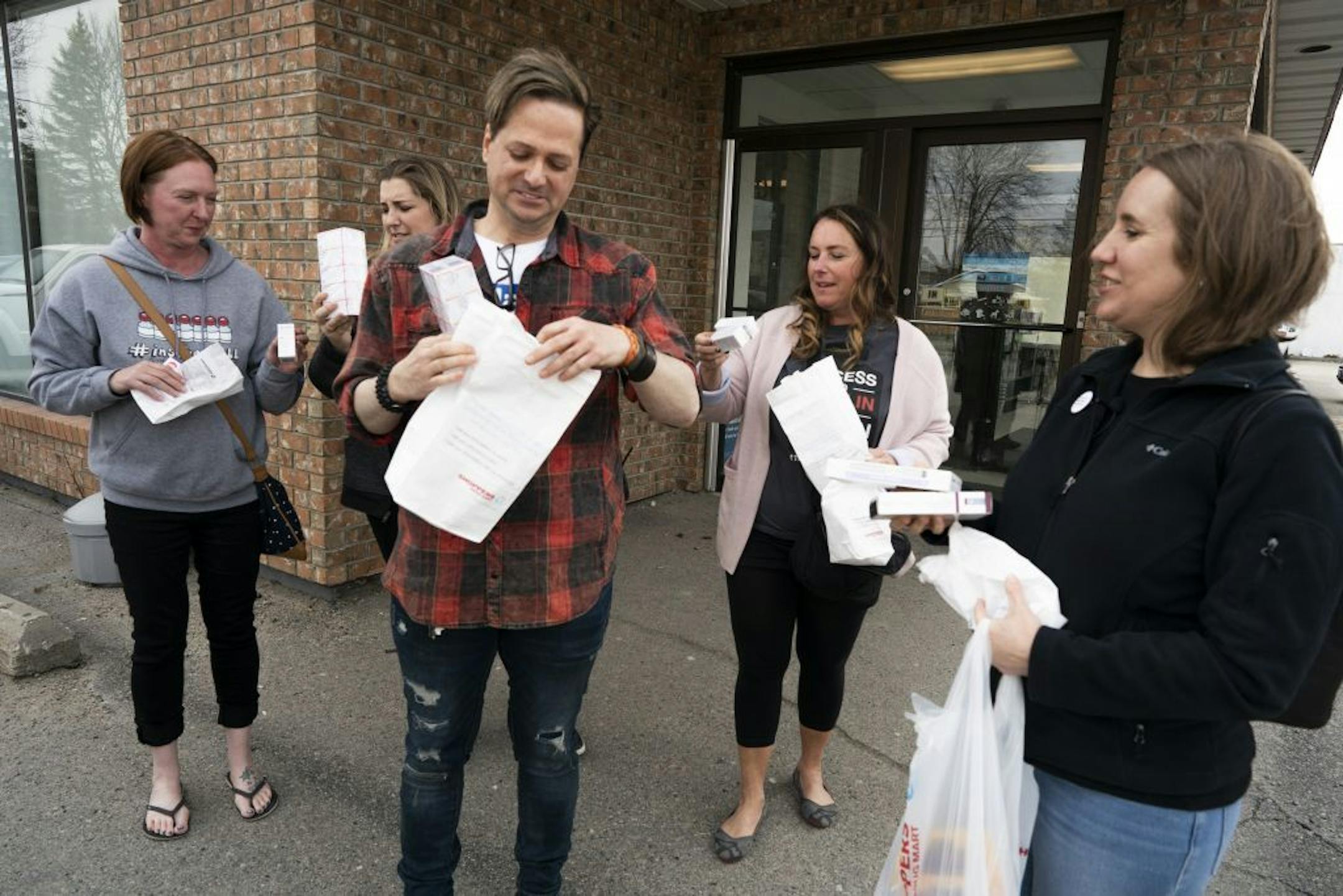 Nicole Smith-Holt, left Quinn Nystrom , Travis Paulson , Vicky Luedtke, and Lija Greenseid stood outside Shoppers Drug Market pharmacy with a 3-month supply of insulin Saturday May 4, 2019 in Ft. Frances, Ontario.