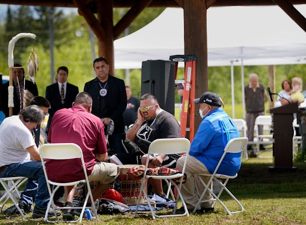 The Bois Forte Singers, including lead singer David Morrison Jr., center, performed an honor song during a ceremony at the Bois Forte Reservation in J