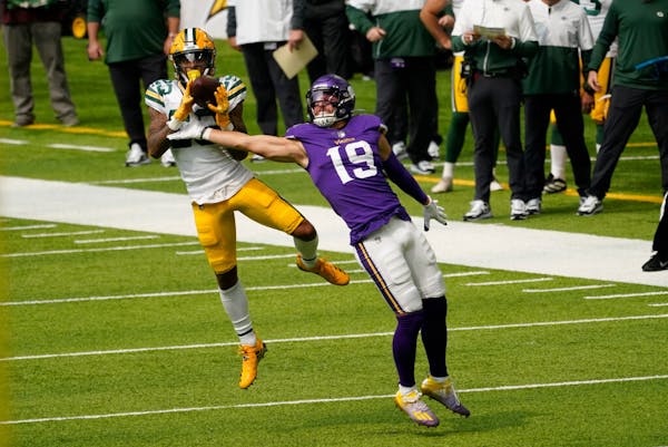 Packers cornerback Jaire Alexander intercepts a pass intended for Adam Thielen during Week 1.