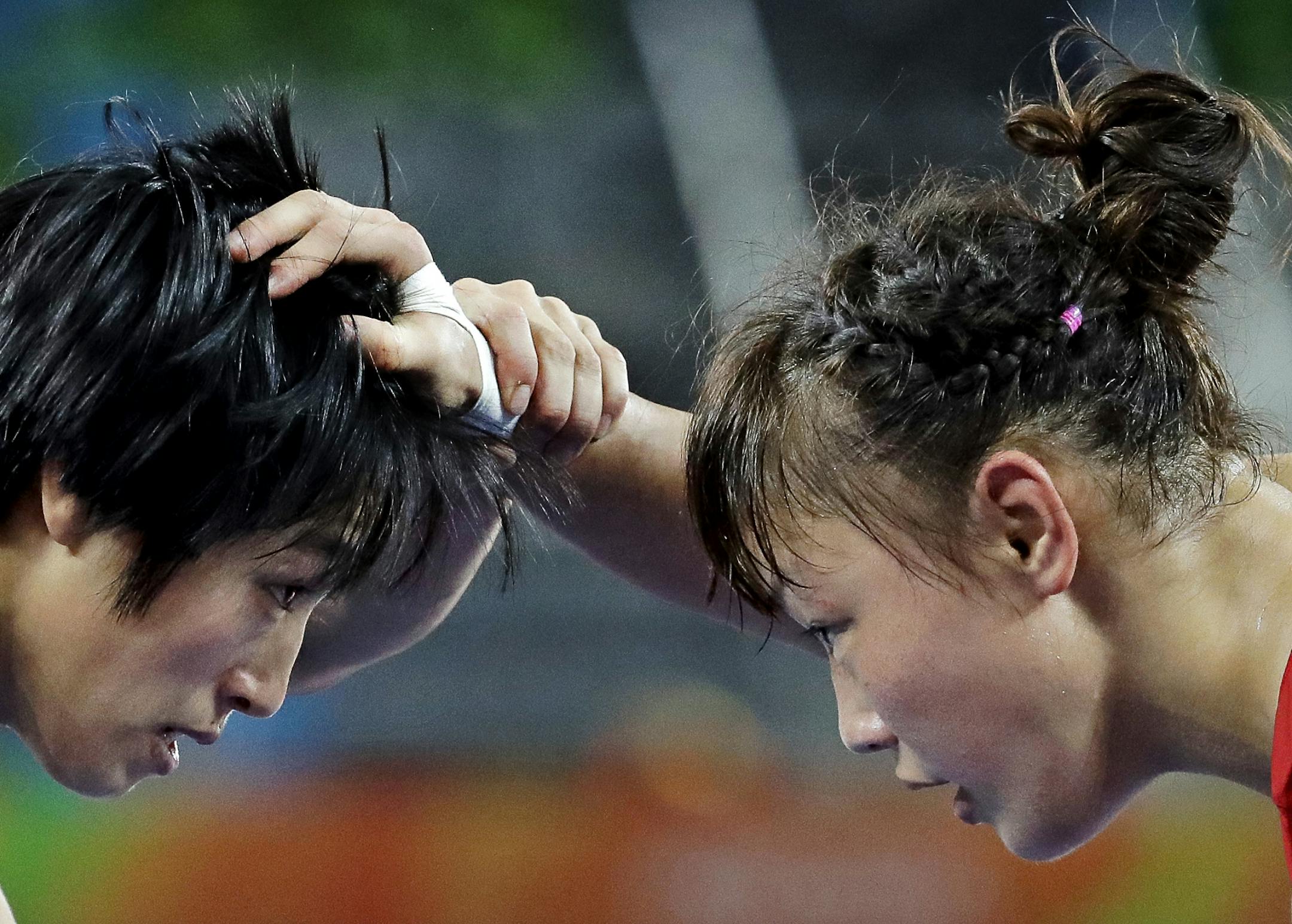 China's Sun Yanan, left, and Japan's Eri Tosaka compete during the women's wrestling freestyle 48-kg competition at the 2016 Summer Olympics in Rio de Janeiro, Brazil, Wednesday, Aug. 17, 2016.