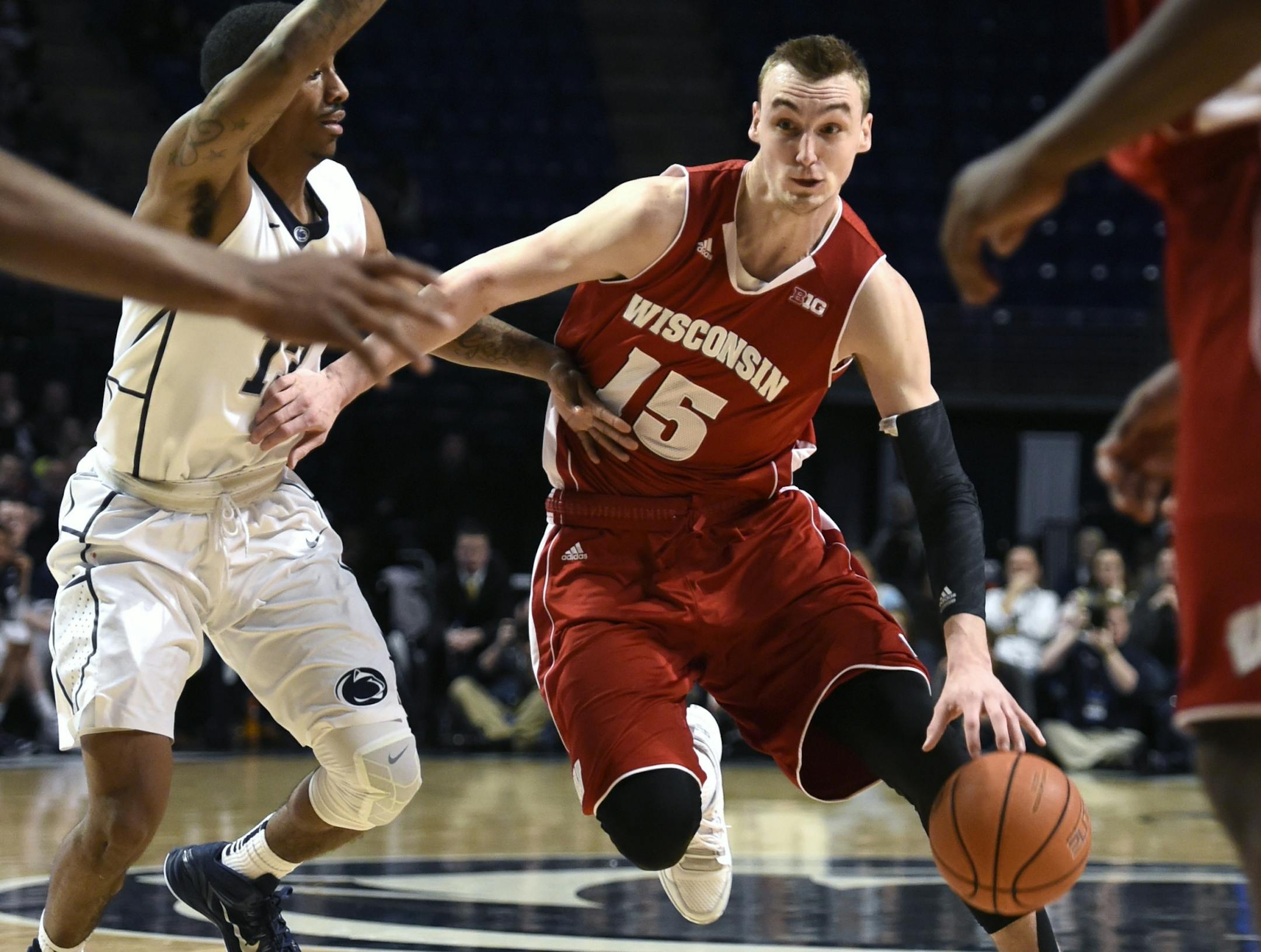 Wisconsin forward Sam Dekker (15) tries to elude Penn State guard Geno Thorpe (13) during an NCAA college basketball game, Wednesday, Feb. 18, 2015, in State College, Pa. Wisconsin won 55-47. (AP Photo/John Beale) ORG XMIT: MIN2015021821163662