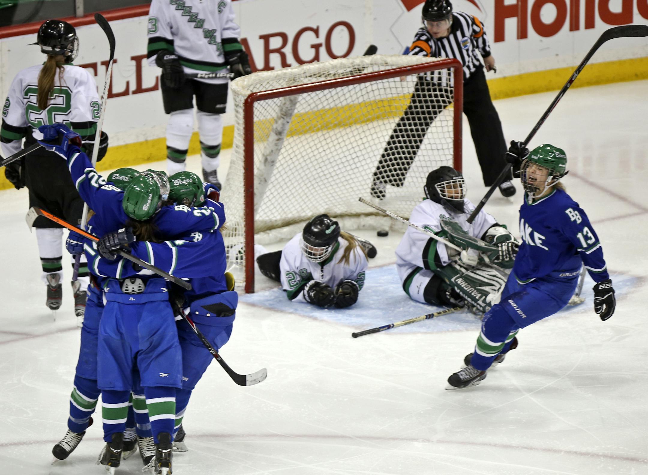 Carly Bullock, front left, celebrates her assist with teammates on a goal by Sylvie Wallin (13) that helped The Blake School win its second straight state title in 2014.