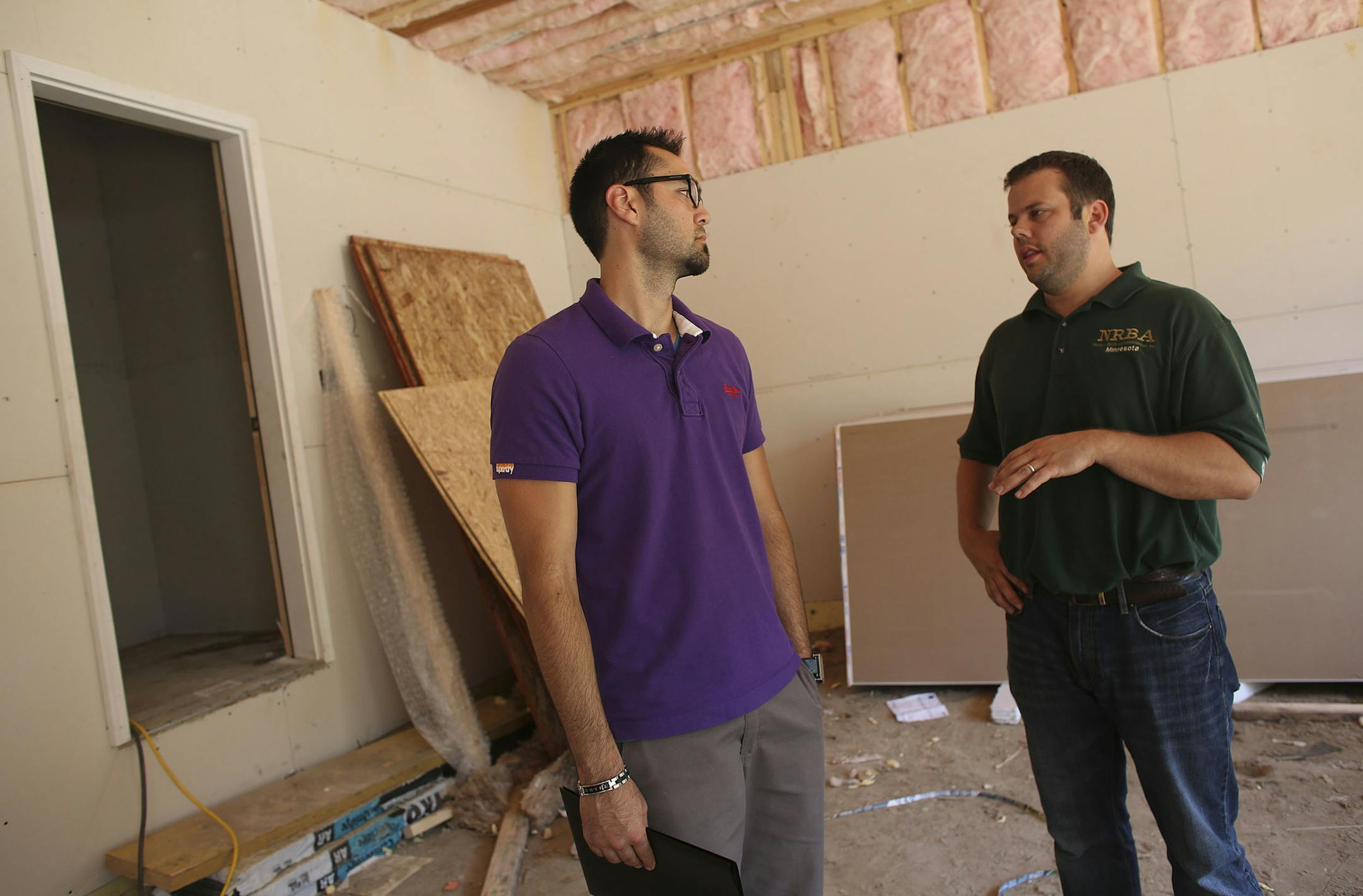 In the garage, realtor Jason Stockwell, right, showed Justin Jahangiri around some of the features and layout of a home in Edina Min., Friday, July 19, 2013 . ] (KYNDELL HARKNESS/STAR TRIBUNE) kyndell.harkness@startribune.com