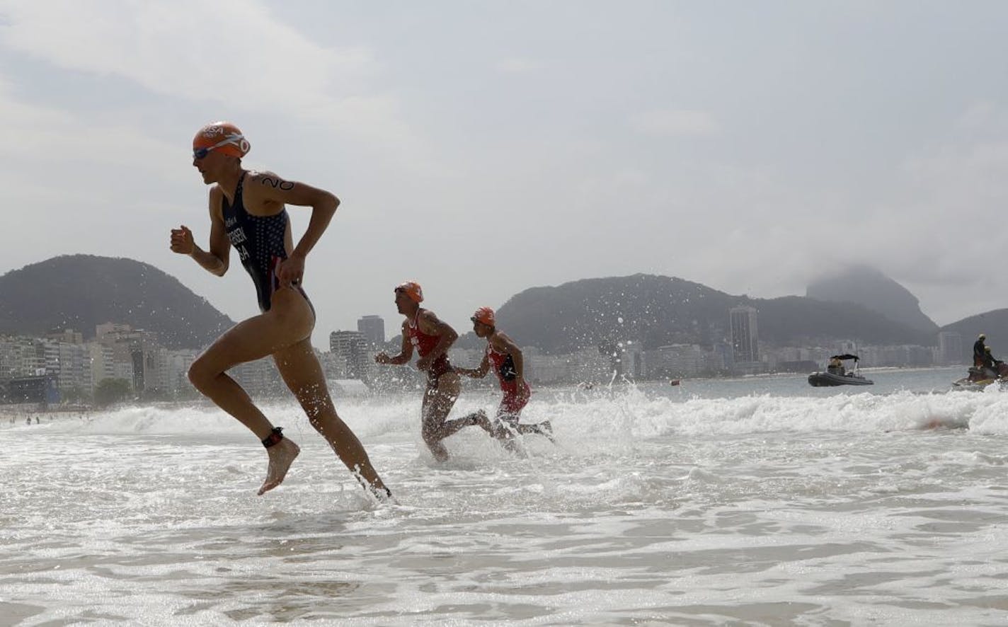 Gwen Jorgensen of the United States, left, exits the water during the women's triathlon competition of the 2016 Summer Olympics in Rio de Janeiro on Saturday.