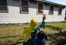 A volunteer at Fort McCoy U.S. Army base in Wisconsin plays Frisbee with Afghan refugees on Sept. 30, 2021.