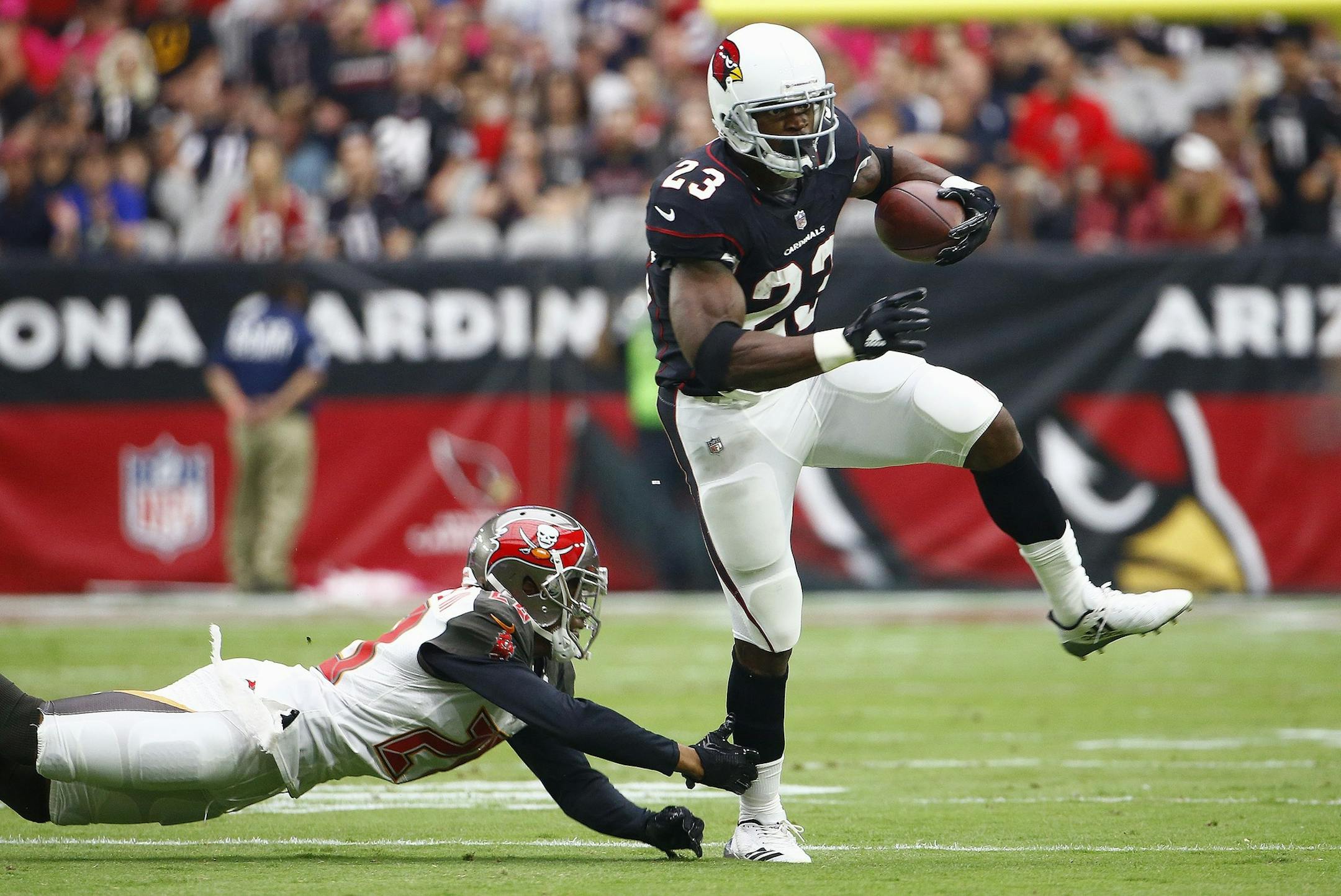 Arizona Cardinals running back Adrian Peterson (23) eludes Tampa Bay Buccaneers cornerback Vernon Hargreaves (28) during the first half of an NFL football game, Sunday, Oct. 15, 2017, in Glendale, Ariz. (AP Photo/Ralph Freso)