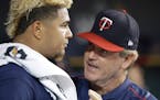Minnesota Twins starting pitcher Adalberto Mejia talks with pitching coach Neil Allen after being pulled during the sixth inning of a baseball game ag