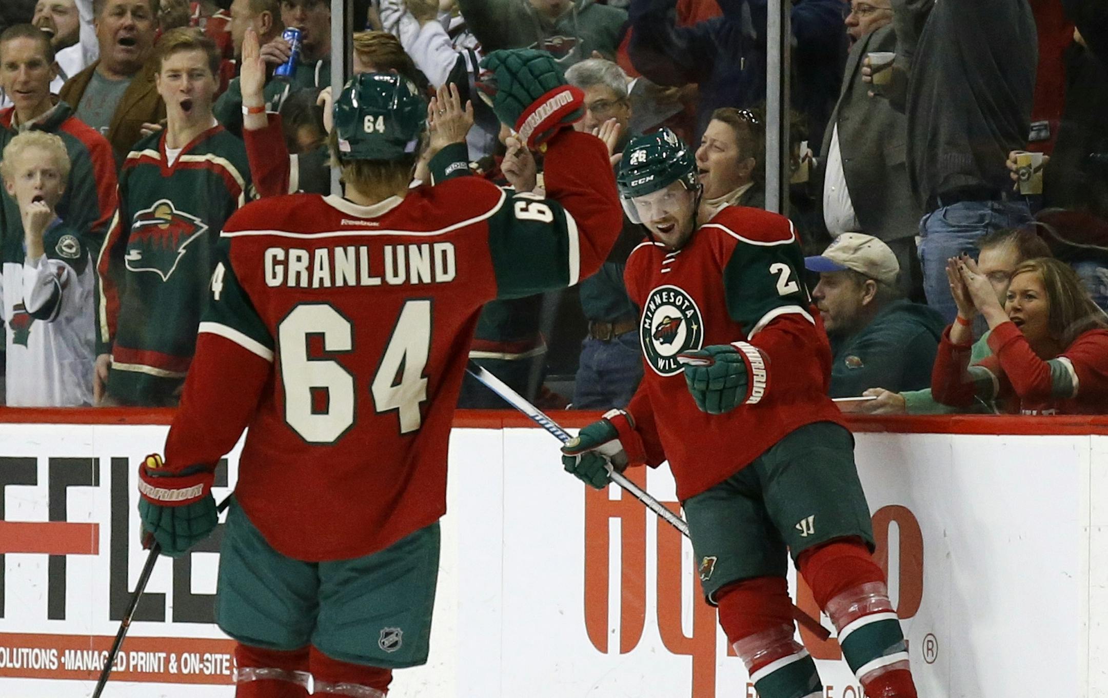 Minnesota Wild left wing Thomas Vanek (26), of Austria, celebrates with teammate Mikael Granlund (64), of Finland, after Vanek's goal on Winnipeg Jets goalie Ondrej Pavelec during the second period of an NHL hockey game in St. Paul, Minn., Tuesday, Nov. 10, 2015. The Wild won 5-3. (AP Photo/Ann Heisenfelt)