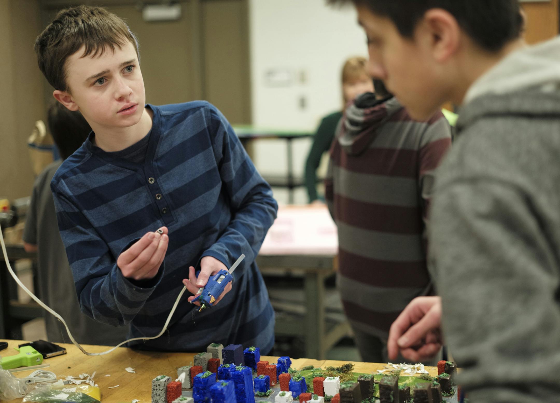 At Rosemount Middle School, Jack Flom,13, and Michael Stefanko,14, work on their model of the city "Altona" which is supplied by a Thorium nuclear reactor and geothermal heat pumps. The competition asks students to solve global problems by designing their own vision of a city in the future. This year's focus is on transportation issues, and students use both Sim City software and real-world materials to design their model..]rtsong-taatarii@startribune.com