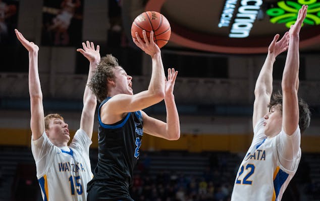 Minnetonka guard Greyson Uelmen attempts a shot against Wayzata defenders during the 2024 Class 4A state championship game.