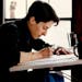 March 16, 1990: Nationally syndicated cartoonist Alison Bechdel at work in her south Minneapolis apartment. Tom Sweeney