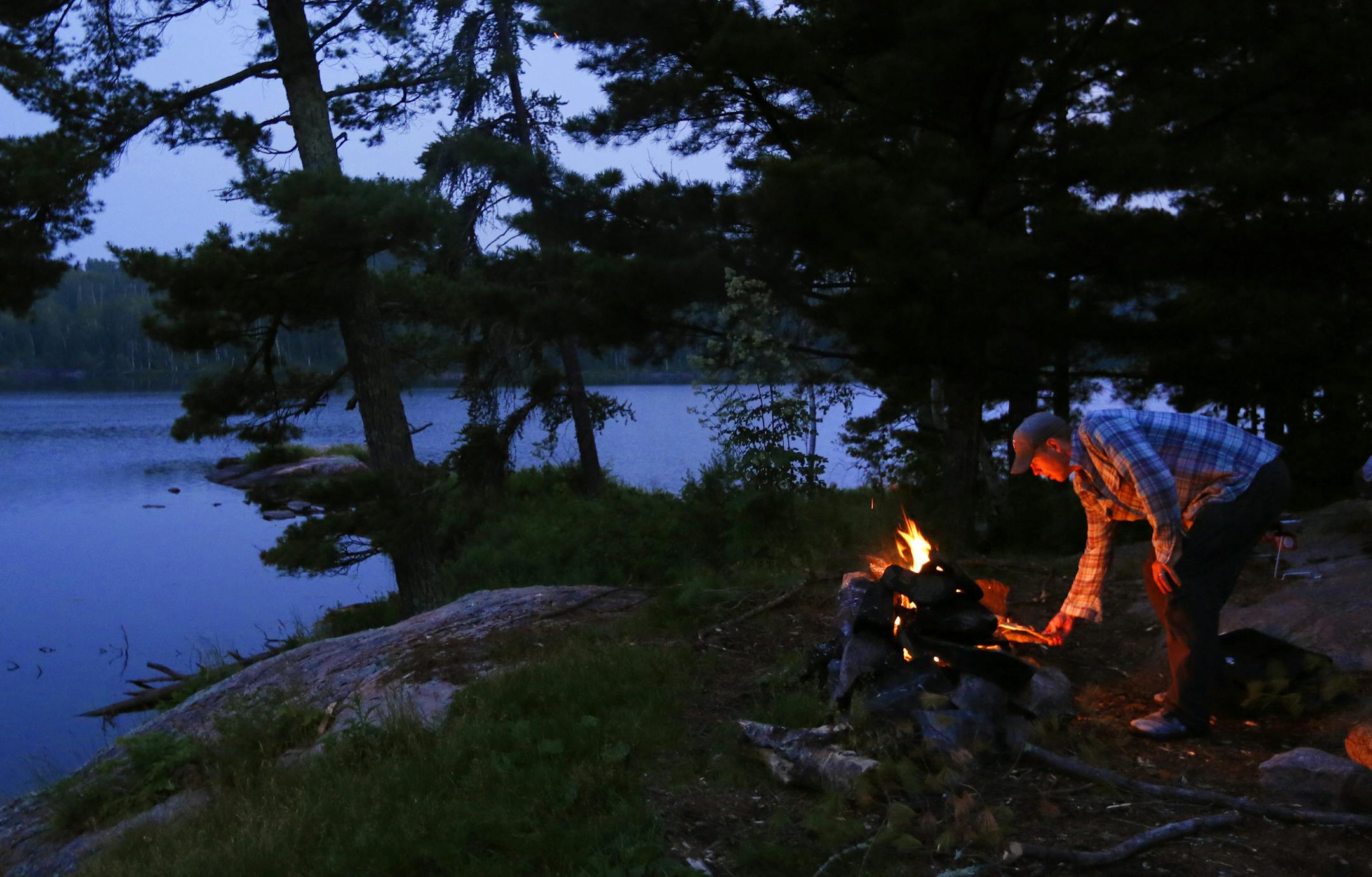 University of Minnesota Ph.D. Student David Chaffin has spent the past two summers counting temperate tree species and the extent of earthworm invasion in the BWCA wilderness. As the Boreal Forest retreats north, places like this pine studded campsite on Upper Pauness Lake could change to maple and oak.] BRIAN PETERSON ‚Ä¢ brianp@startribune.com BWCA, MN - 08/16//2013 ORG XMIT: MIN1308201115244595
