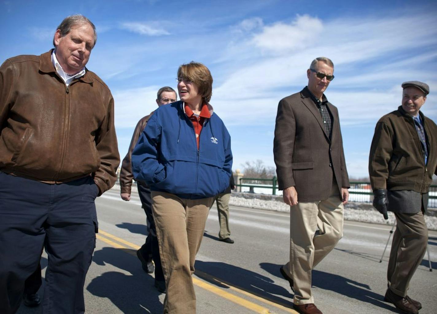 Flanked by Chaska Mayor Mark Windschitl, left, and Carver County management director Ken Carlson, Sen. Amy Klobuchar checked on the flooding of the Minnesota River in March 2011.