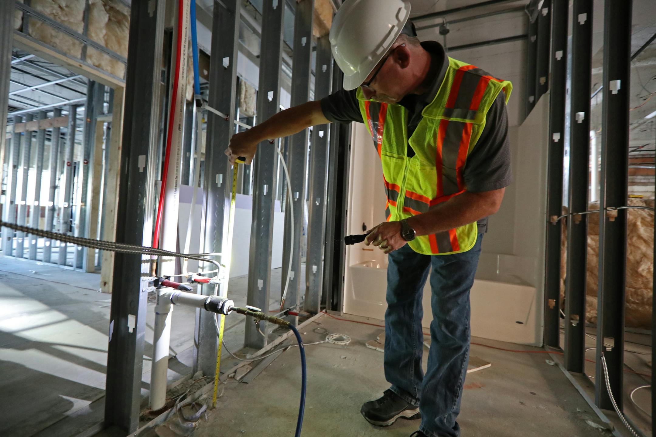 Senior plumbing inspector Richard Jacobs did a visual inspection on plumbing going into a building in downtown St. Paul in this file photo from September 2018. (Staff photo by Shari L. Gross, shari.gross@startribune.com)