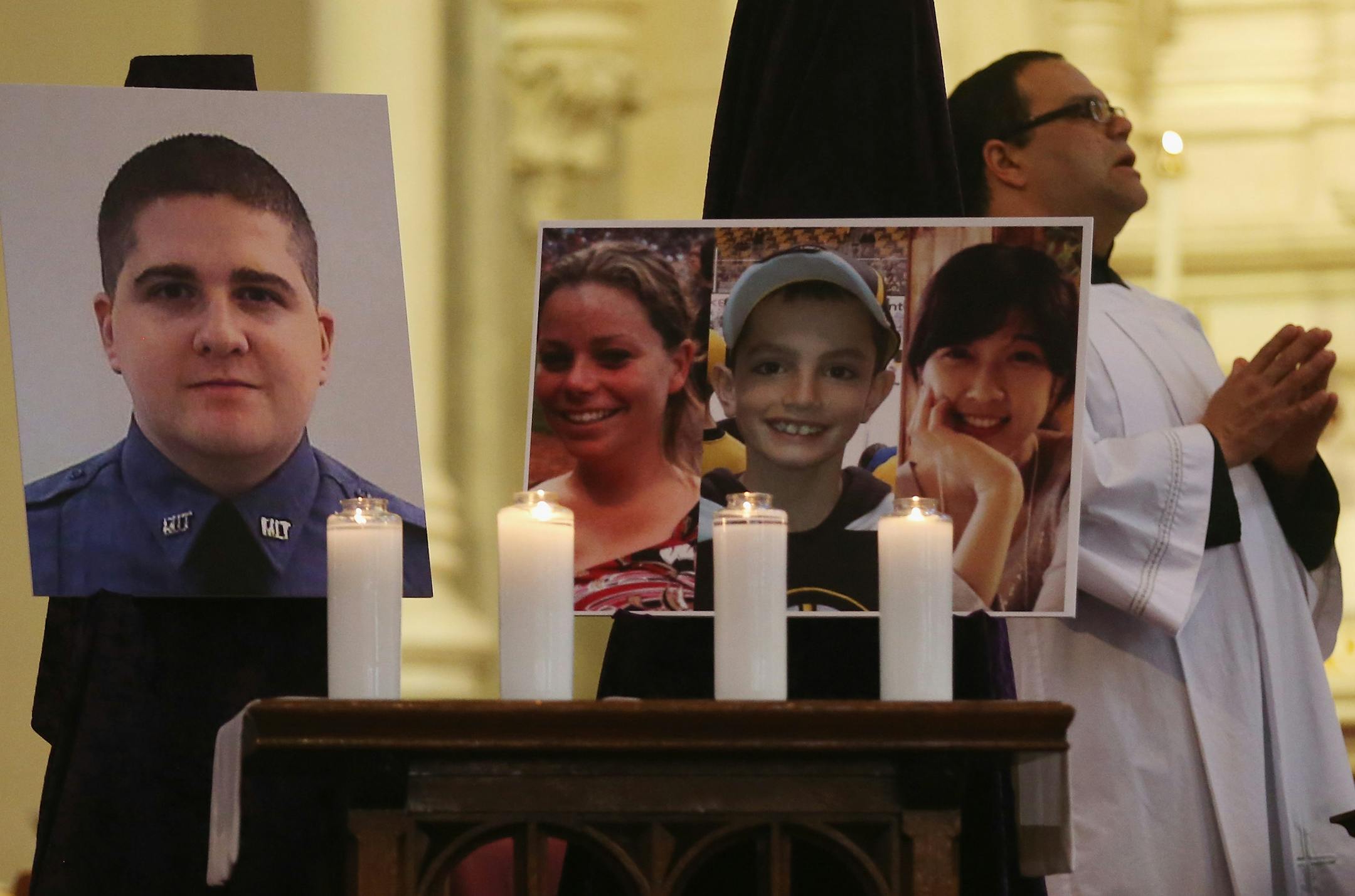 BOSTON, MA - APRIL 21: Photos of the deceased are displayed during Mass at the Cathedral of the Holy Cross on the first Sunday after the Boston Marathon bombings on April 21, 2013 in Boston, Massachusetts. The Mass honored the victims of the bombings and subsequent manhunt as well as first responders. (Photo by Mario Tama/Getty Images) ORG XMIT: 167266044