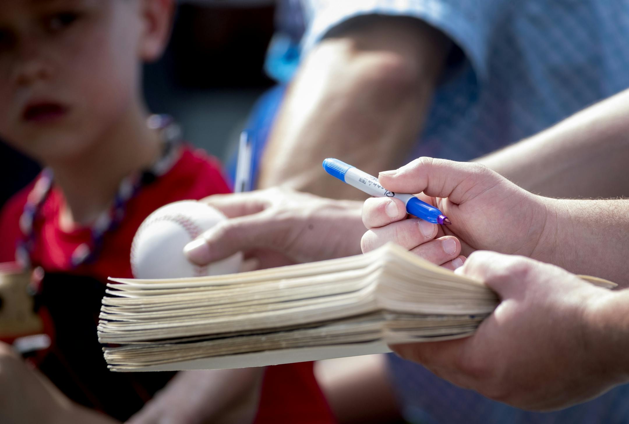 Fans held out items in hope of getting an autograph at the first day of practice for position players.