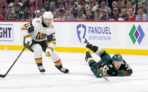 Kirill Kaprizov (97) of the Minnesota Wild reaches for the puck against the Vegas Golden Knights in the second period at Xcel Energy Center in St. Pau