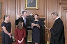 Chief Justice John Roberts, right, administers the Constitutional Oath to Judge Brett Kavanaugh in the Justices' Conference Room of the Supreme Court 