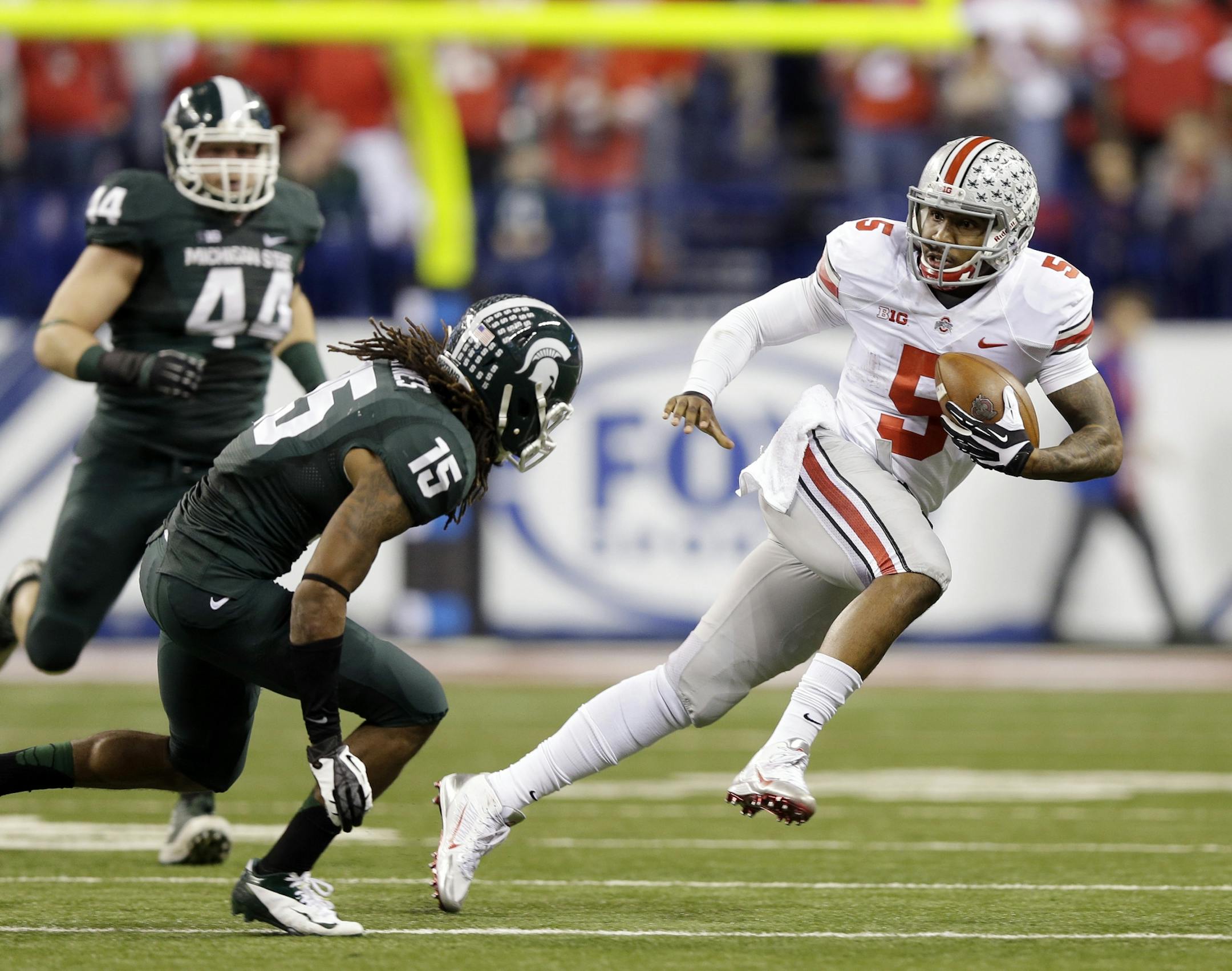 Ohio State's Braxton Miller (5) runs against Michigan State's Trae Waynes (15) during the first half of a Big Ten Conference championship NCAA college football game Saturday, Dec. 7, 2013, in Indianapolis.